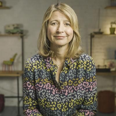 a woman in a colorful shirt is sitting down