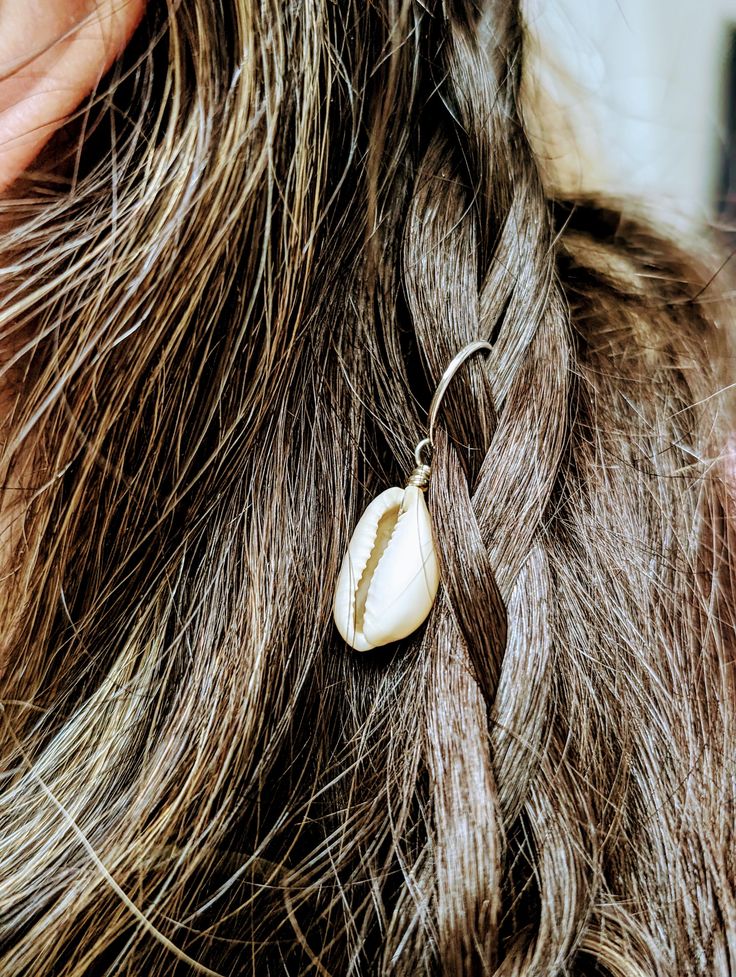 The perfect accessory for any beach lover! Especially those who love to collect sea shells or channeling their inner mermaid. Description: Created out of authentic Cowrie shells and come in a set of three hair charms, available in silver or gold. Made out of stainless steel hardware, to ensure they are water proof. Just clip in your beach waves and braids and enjoy those bohemian vibes. Vacation Shell-shaped Jewelry With Pearl Charm, Ocean-inspired Pearl Charm Jewelry For Beach, Shell Jewelry With Pearl Charm For Vacation, Vacation Shell Jewelry With Pearl Charm, Silver Dangle Jewelry With Shell, Nickel-free Ocean-inspired Shell-shaped Shell, Nickel-free Ocean-inspired Shell, Ocean-inspired Nickel-free Shell-shaped Shell, Beach Jewelry With Shell-shaped Pearl Charm