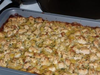 a casserole dish with chicken and broccoli in it on a stove