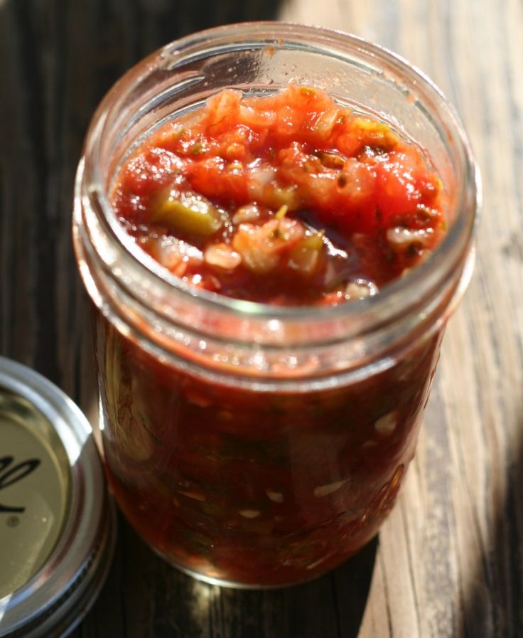 a jar filled with food sitting on top of a wooden table