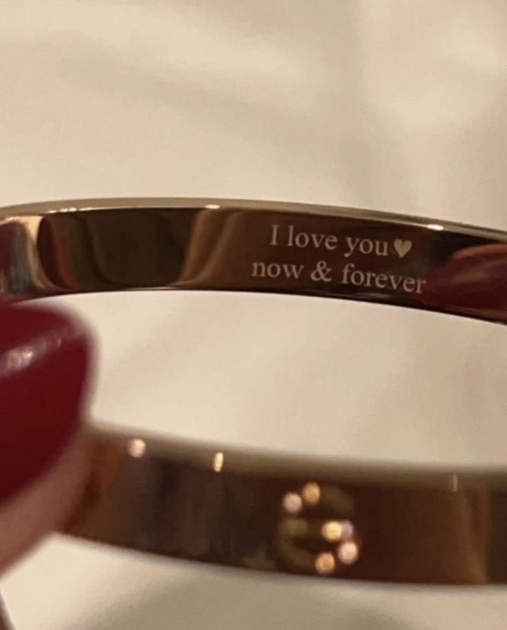 a close up of a ring with the words i love you now and forever on it