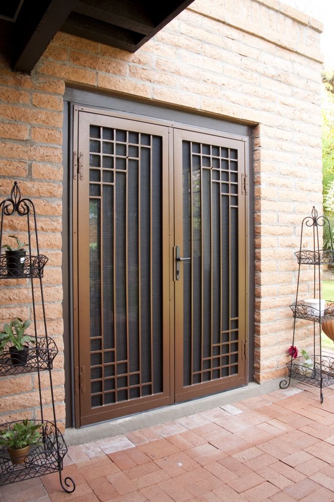 two doors are open on the outside of a house with brick walls and stone flooring