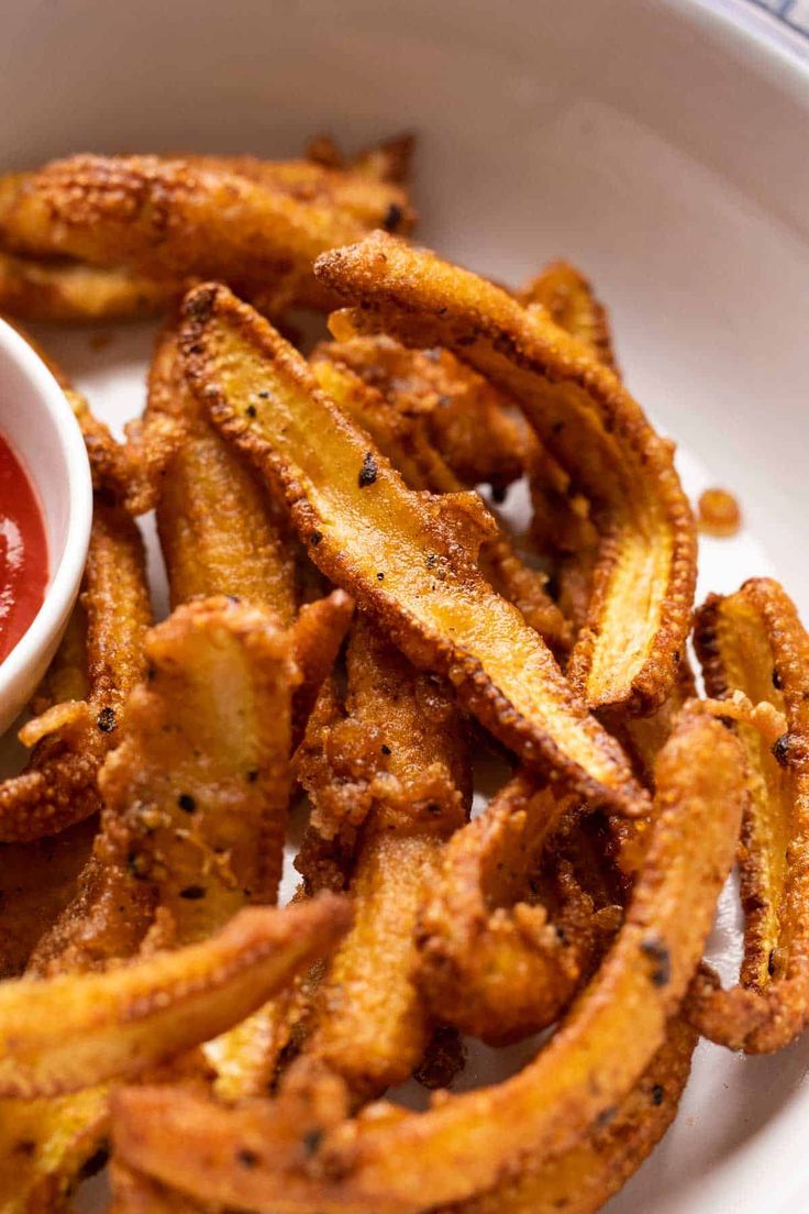 a white plate topped with french fries and ketchup