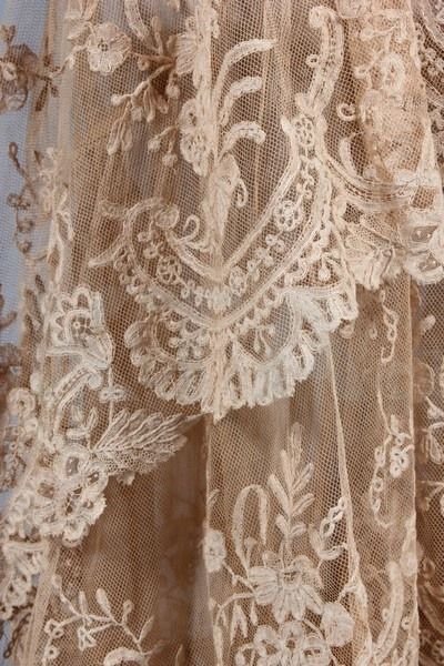 an old lace curtain with flowers on it