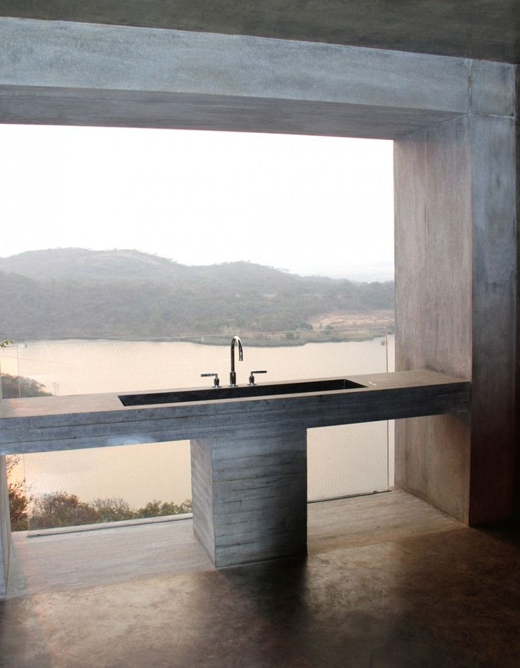 an instagram photo of a sink in a room with a window overlooking the water