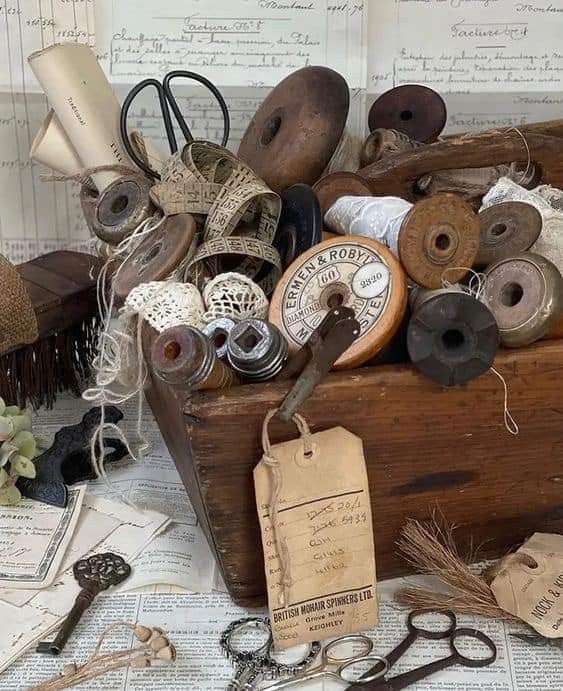 an old wooden box filled with lots of different types of sewing thread and spools