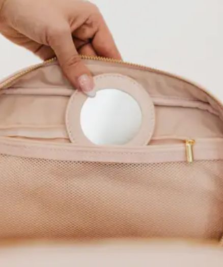 Introducing your new BFF - our Madelyn Bow Makeup Bag! This makeup bag has plenty of room for all your beauty products, hair essentials, and more. Plus, there's a zipper pocket with a compact mirror for on-the-go touch-ups. Perfect for stylish travelers and it's easy to clean too! Compact mirror inside Bag measures: 10"L x 7"W x 4.5"H Spot clean Portable Round Case Travel Bag, Compact Functional Cosmetic Bag For On-the-go, Travel Cosmetic Storage Pouch With Zipper Closure, Travel Cosmetic And Toiletry Pouch With Zipper, Compact Travel Cosmetic Bag With Zipper, Compact Portable Cosmetic Bag For Travel, Versatile Round Case Travel Bag, Compact Portable Travel Cosmetic Bag, Blush Travel Pouch Bag