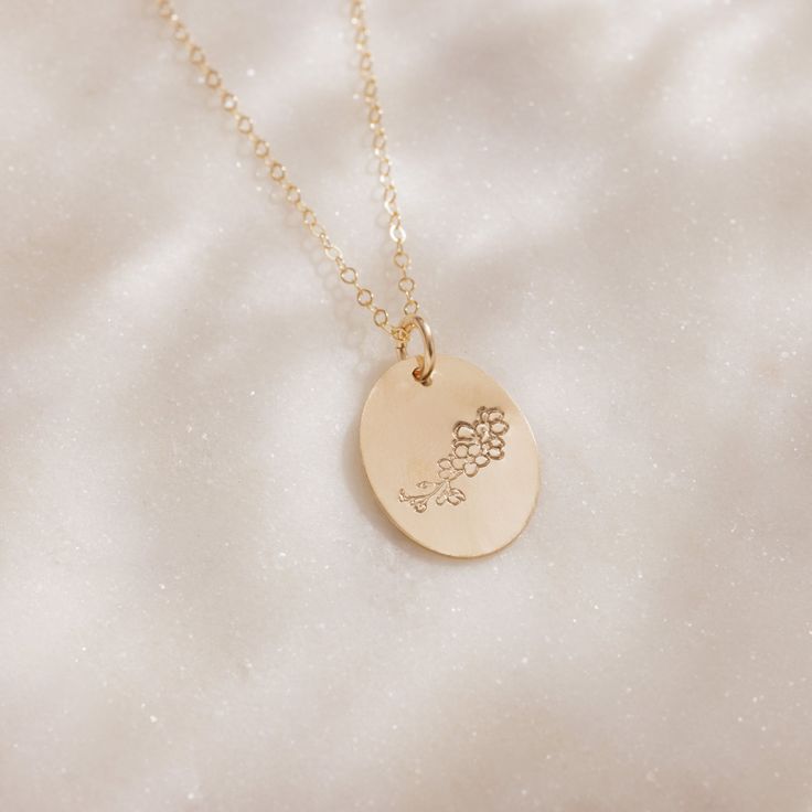 Delicate with a touch of whimsy, this hand-stamped pendant necklace features a flower design that represents your birth month. From the petite snowdrops of January to the classic holly of December, every month is represented (and some with two), making the Birth Month Necklace a great gift for moms, grandparents and friends, or any nature lover in your life. We love the subtle femininity it offers on its own, but because the oval pendant is suspended from a dainty gold chain that falls just belo Delicate Charm Necklace With Flower Pendant, Personalized Flower Jewelry For Everyday, Delicate Round Pendant Charm Necklaces With Flower Charm, Delicate Charm Necklace With Round Flower Pendant, Engraved Flower Pendant Jewelry For Everyday, Delicate Hand Stamped Necklace For Gift, Dainty Stamped Necklaces For Mother's Day, Dainty Stamped Necklace For Mother's Day, Everyday Engraved Flower Pendant Jewelry