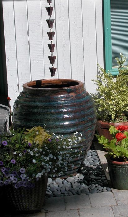 several potted plants sitting on the side of a building