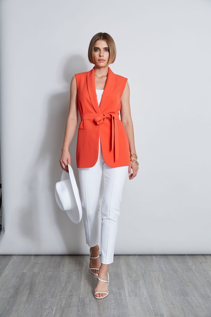 Designed with a removable self-sash & effortless fit, this vest is the summer layer your wardrobe needs. Crafted in our favorite crepe, this vest is ultra cool. You will love the look & feel of this standout piece. Wear it with its matching pant for a modern column of color or mix it with denim for a more casual vibe. Mid-Length Vest with Self Sash Runs true to Size Model is 5'9" and wearing size 2 Dry Clean Only Imported Style #: ETR41358 Modern Fitted Spring Vest, Spring Fitted Vest With Zipper Closure, Fitted Sleeveless Vest With Zipper Closure, Stretch V-neck Vest For Beach, Beach V-neck Stretch Vest, Summer Layers, Woven Handbags, Jumpsuit Jacket, Long Sleeve Short Dress