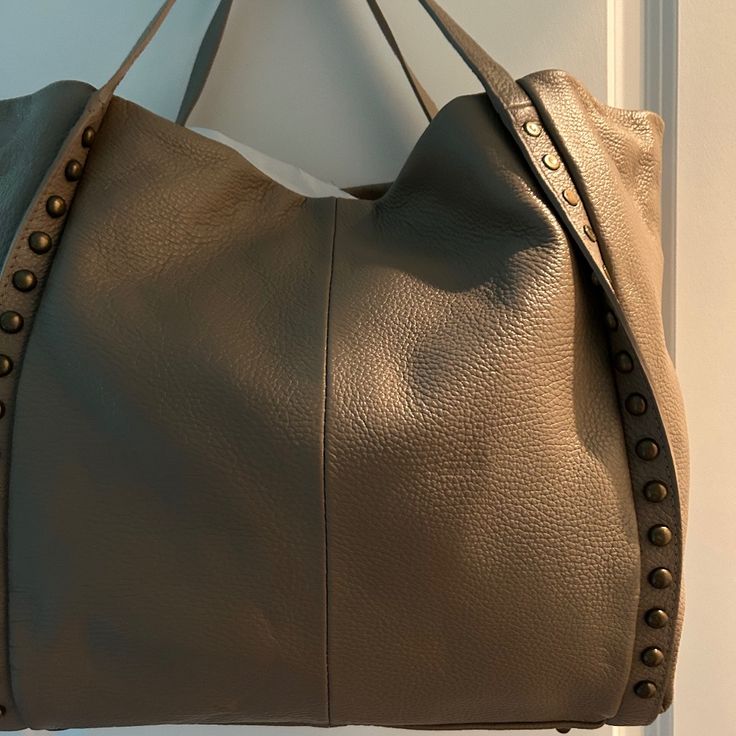 Nice Subtle Leather Brass Studs Beige Leather Hobo Bag For Errands, Beige Leather Satchel For Errands, Taupe Leather Shoulder Bag With Double Handle, Taupe Leather Bag With Adjustable Strap, Taupe Leather Hobo Bag For Daily Use, Taupe Leather Bag For Daily Use, Beige Leather Hobo Bag For Shopping, Taupe Leather Bag With Leather Handles, Taupe Soft Leather Shoulder Bag With Double Handle