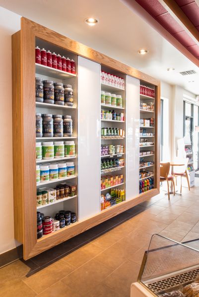 a store filled with lots of different types of food and drinks on glass shelves next to each other