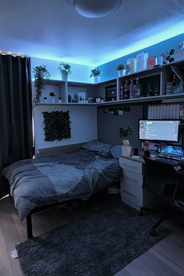 a bedroom with a bed, desk and computer