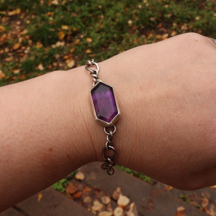 A rich purple amethyst makes this simple everyday chain transform into an iconic style accessory. Stone meanings: Amethyst is associated with the Third Eye and Crown chakras, which are said to promote spiritual growth, intuition, and higher consciousness. Amethyst is said to promote clarity and insight, and to calm the mind. Details: This unique bracelet features up cycled silver chain and a beautifully cut amethyst stone. All Bracelets are able to be made shorter. If you need additional chain o Purple Meditation Bracelet Jewelry, Mystical Nickel-free Purple Jewelry, Mystical Purple Nickel-free Jewelry, Everyday Purple Amethyst Bracelet, Mystical Purple Jewelry For Meditation, Nickel-free Amethyst Bracelet, Purple Jewelry Bracelet With Adjustable Chain, Purple Bracelet With Adjustable Chain As Gift, Purple Bracelet Jewelry For Everyday