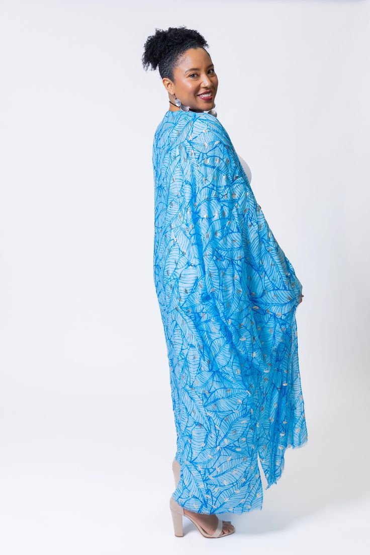 Elevate your summer style with the elegant touch of silver featured in this lightweight kimono. Its versatility makes it ideal for beach days, lunches, or date nights, ensuring you'll make a statement wherever you go this season. Elegant Blue Kimono For Summer, Light Blue Summer Kaftan, Blue Cover-up For Summer Party, Blue Summer Party Cover-up, Blue Wrap Kimono For Beachwear, Summer Light Blue Kaftan, Elegant Summer Vacation Kimono, Blue Kimono For Beach Season, Blue Wrap Kimono For Summer