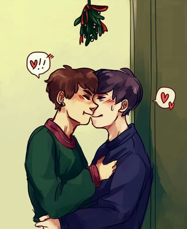 two young men are hugging each other in front of a christmas tree with hearts hanging from it