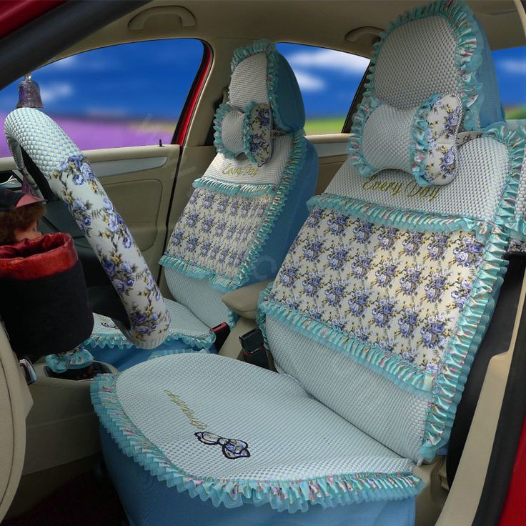 the interior of a car is decorated with blue and white flowers on it's seat covers