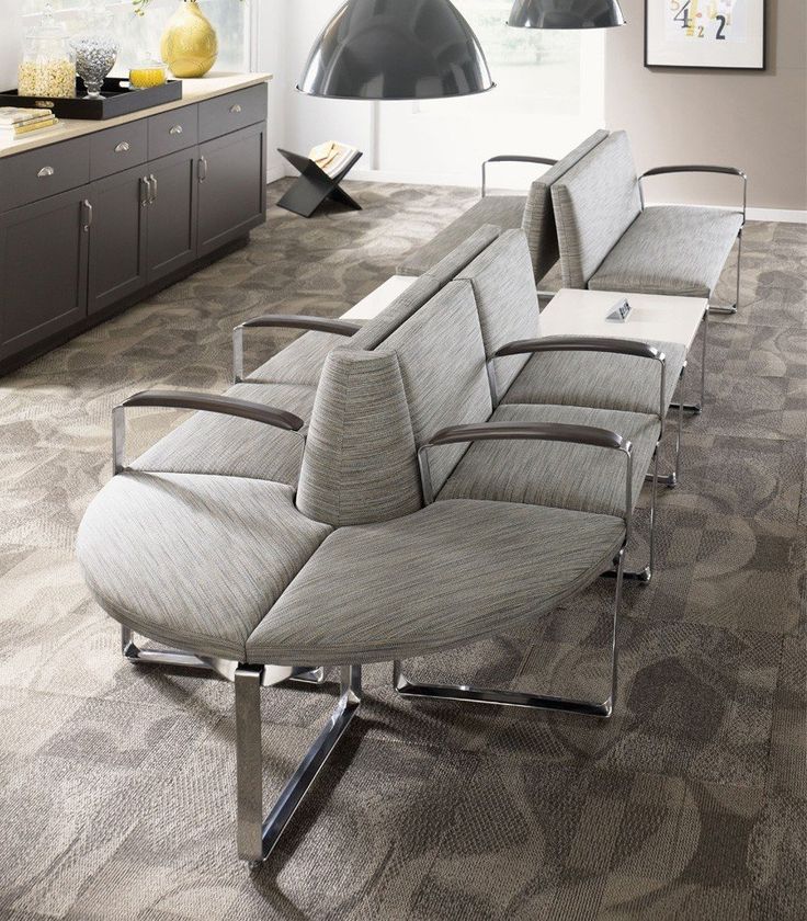 a row of chairs sitting on top of a carpeted floor