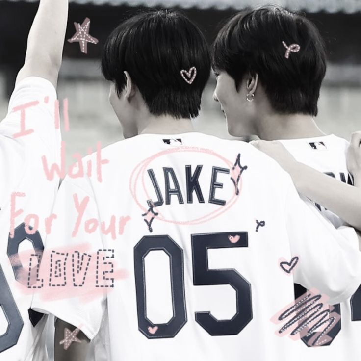 two young men wearing baseball uniforms with writing on them