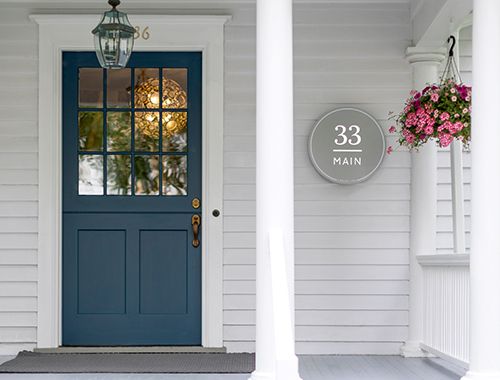 a blue front door on a white house