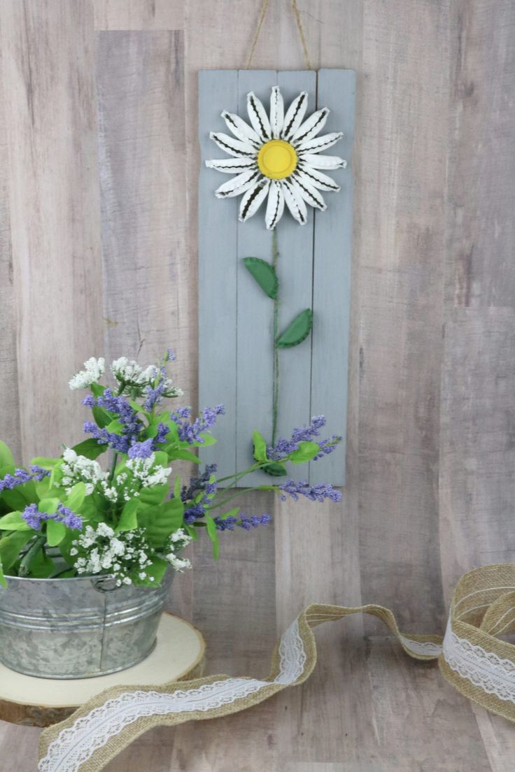 a potted plant sitting next to a wooden sign