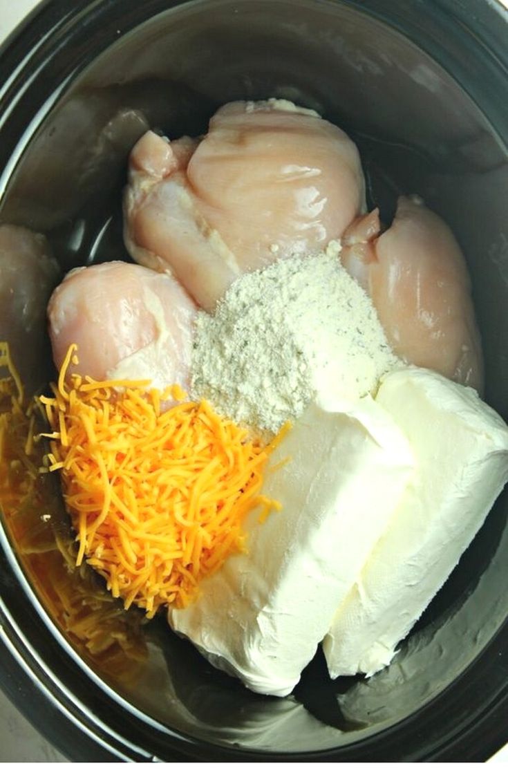 chicken, cheese and other ingredients in a slow cooker