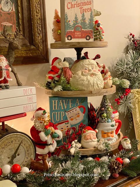 christmas decorations are displayed on top of a table