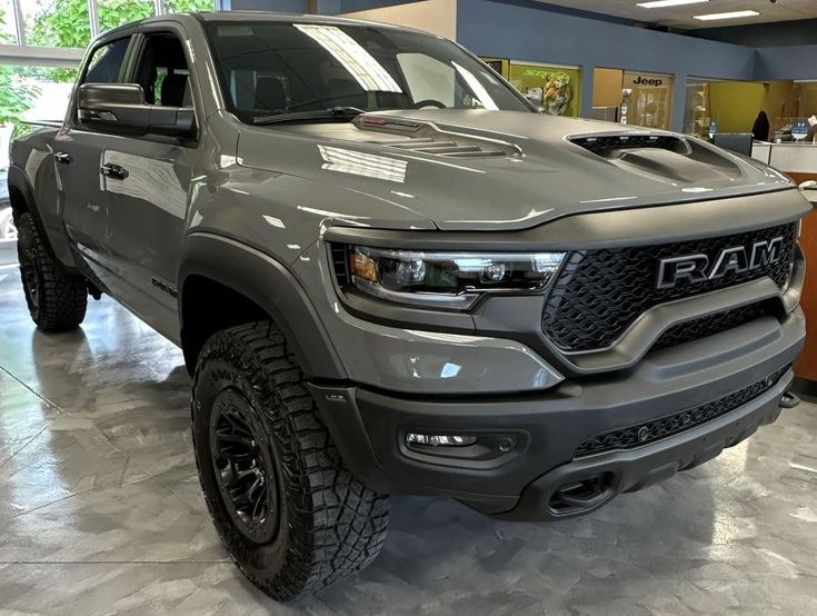 a gray truck is parked in a showroom