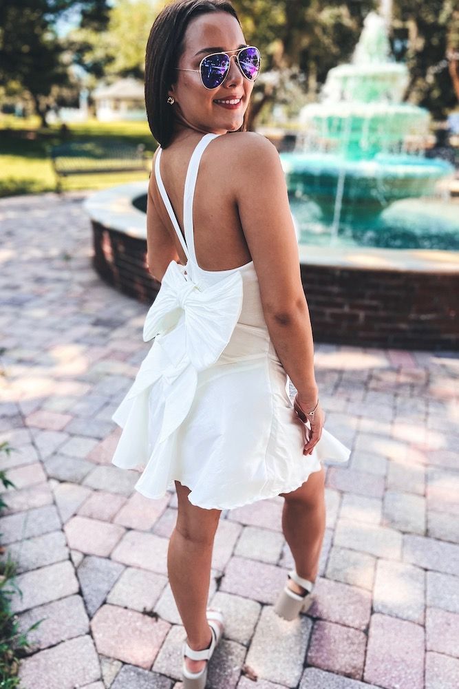 Bow Back Dress | Sophie & Trey Flirty Backless Dress With Ruffle Hem, Backless Sundress With Ruffle Hem, Chic Backless Midi Dress With Ruffles, Cotton Tie-back Dress For Date Night, Cotton Tie Back Dress For Date Night, Elegant Mini Dress With Bow Tie Back For Spring, Backless Ruffle Hem Dress For Date Night, Summer Bow Tie Back Mini Dress For Cocktail, Backless Dress With Ruffle Hem For Date Night