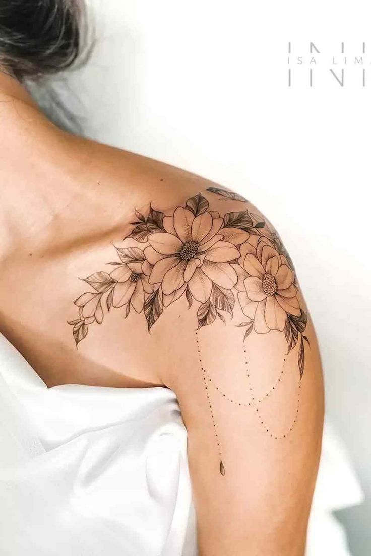 a woman's shoulder with flowers on it