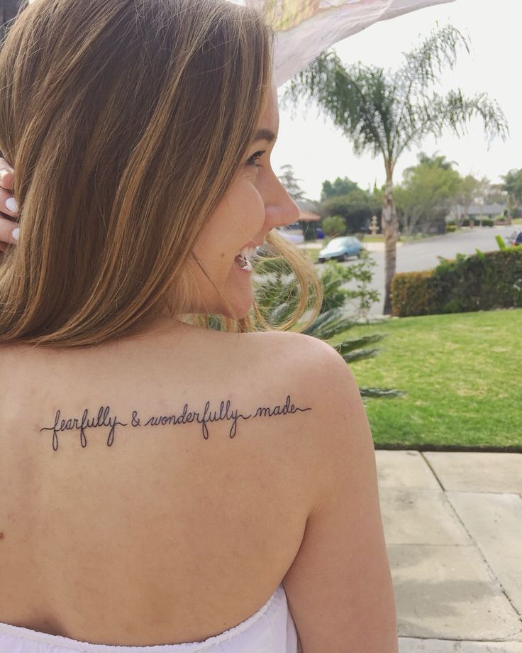 a woman with a tattoo on her back saying, family is wonderfully made