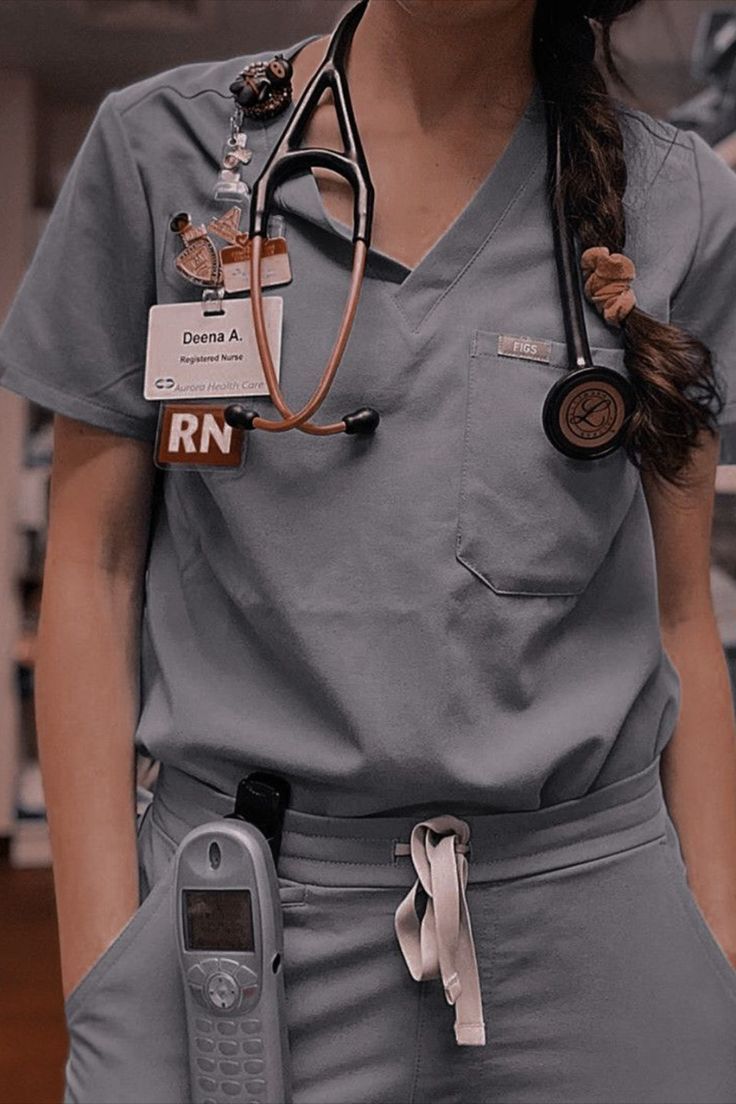 a woman in grey scrubs with a stethoscope attached to her chest