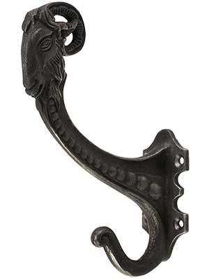 a black metal hook with a lion head on it's end and two holes in the middle