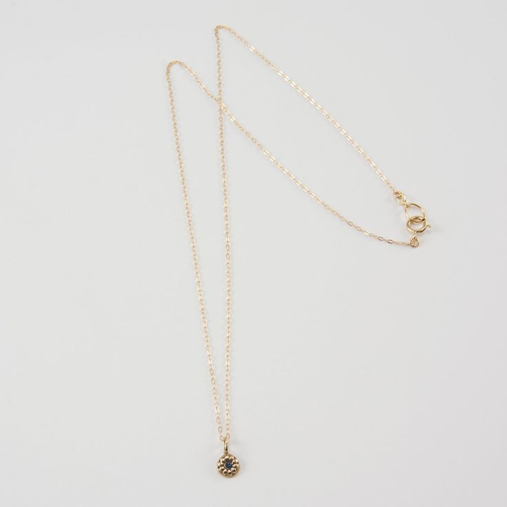 Keep it simple with the DELIA Tiny Flower Pendant Necklace. Small but with a lot of style, accentuate your look with its distinguished elegance. It grabs the attention not just by its shape but also by its charming 14K gold color. This necklace gives you all the reasons to make it a pick of the day. Features: Comfortable Lightweight Elegant and minimal High quality Hand-carved flower-shaped pendant Size & Material: Length: 17" inches Material: 14K gold chain and pendant with an inset of a diamon Everyday 14k Gold Necklaces With Flower Charm, Everyday 14k Gold Necklace With Flower Charm, Elegant Yellow Gold Round Flower Necklace, Elegant Round Yellow Gold Flower Necklace, Delicate Necklace With Flower Charm And Round Pendant, Elegant Flower Charm Necklace With Round Pendant, Elegant Flower Pendant Charm Necklaces, Minimalist Charm Necklace With Flower Pendant, Everyday Elegant Flower Pendant Charm Necklaces