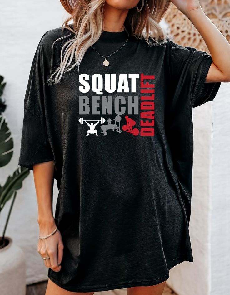 Welcome to our "Flex & Fun" t-shirt line--a fusion of motivation, humor, and dedication to the iron game! Each shirt in our collection is crafted to inspire and energize your workouts while adding a touch of laughter to your gym sessions.  Featuring bold designs and catchy slogans, our tees are the perfect companion for your weightlifting journey. From "Squat Goals" to "Lift Heavy, Laugh Often," our shirts are designed to keep you motivated and smiling through every rep and set. Highlights: - Made from high-quality 100% Airlume combed and ring-spun cotton, meaning that the material goes through a special process to achieve that smooth, perfect finish. -This tee has certain elements, like side seams, a ribbed collar, and twill shoulder taping, that help retain its shape even after multiple Funny Gym Tshirts, Gym Rat Gift, Motivation Humor, Squat Goals, Squat Bench Deadlift, Gym Tshirt, Weightlifting Shirts, Reps And Sets, Funny Workout Shirts