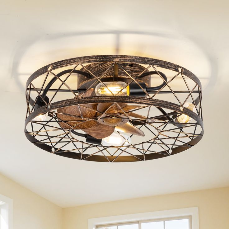 a ceiling fan that is hanging from the ceiling in a room with windows and a window