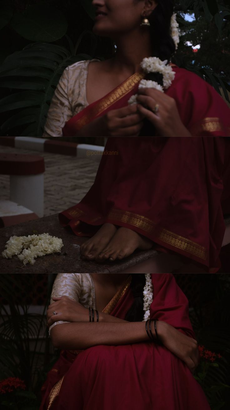 a woman in a red and white sari sitting on a bench with flowers around her neck