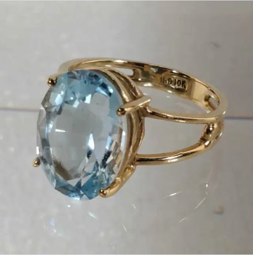 Yellow Gold Light Blue Sapphire Ring Classic Blue Topaz Ring With Vvs Clarity, Formal Sapphire Topaz Ring With High Clarity, Light Blue 14k Gold Formal Jewelry, Blue Topaz Birthstone Ring For Formal Occasion, Light Blue 14k Gold Jewelry For Formal Occasions, Formal Light Blue 14k Gold Jewelry, Oval Aquamarine Birthstone Ring In Blue, Hallmarked Heirloom Blue Topaz Ring, Timeless Blue Topaz Ring Gift