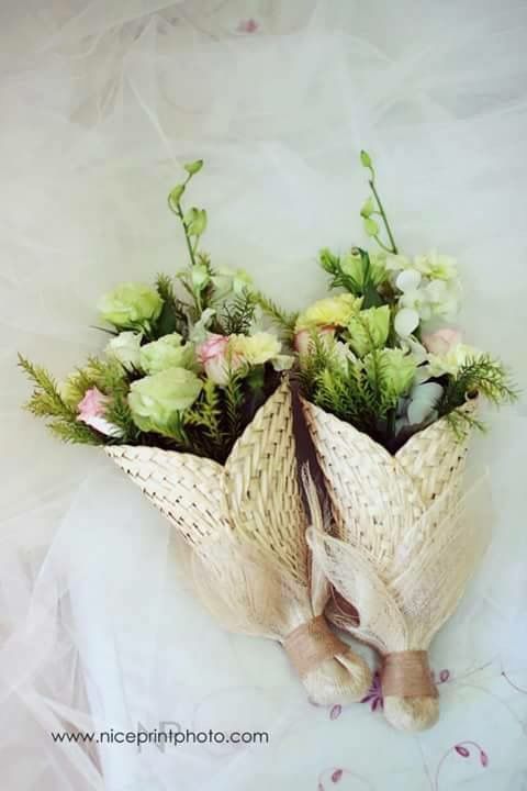 a bouquet of flowers is wrapped in white paper