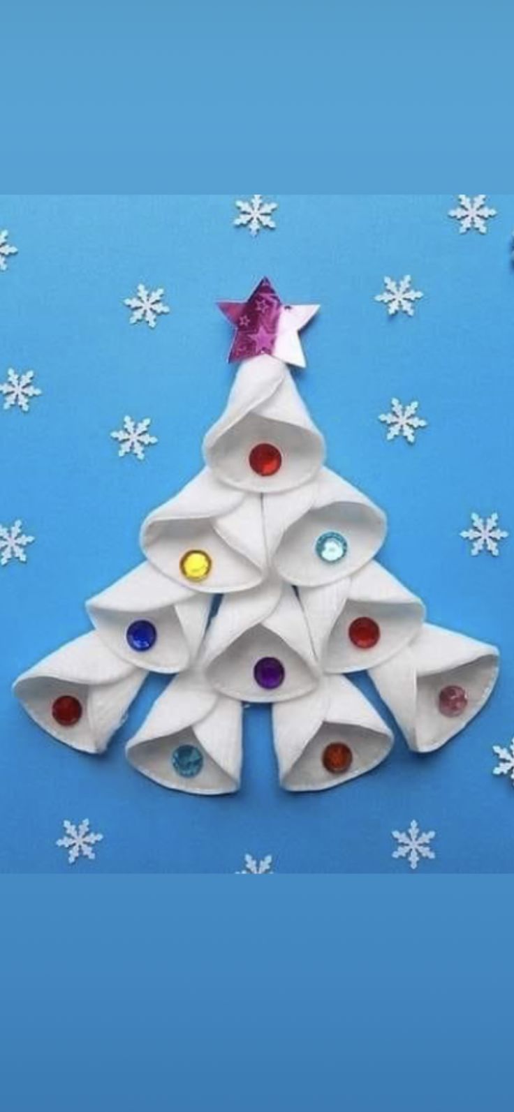 an origami christmas tree made out of white paper with colorful buttons on it