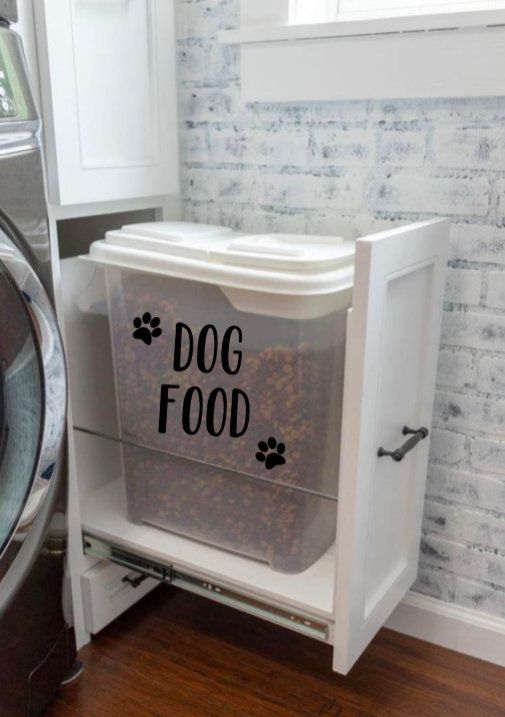 a cat food dispenser sitting next to a washer and dryer