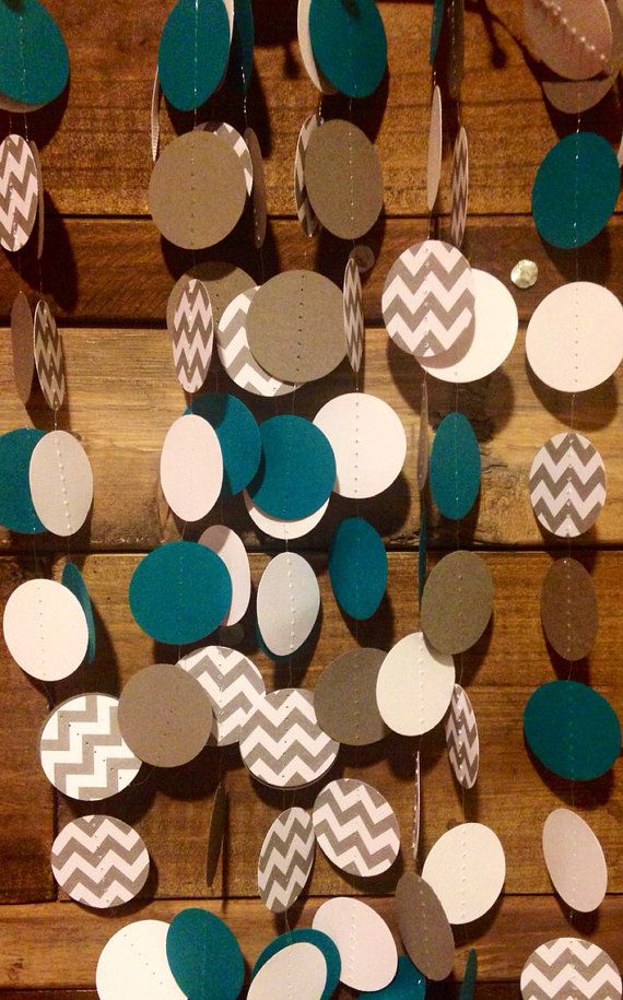 a wooden table topped with lots of paper circles and polka dotes hanging from the ceiling