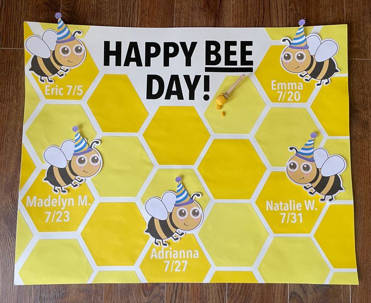 a happy bee day sign on the floor with bees and honeycombs around it