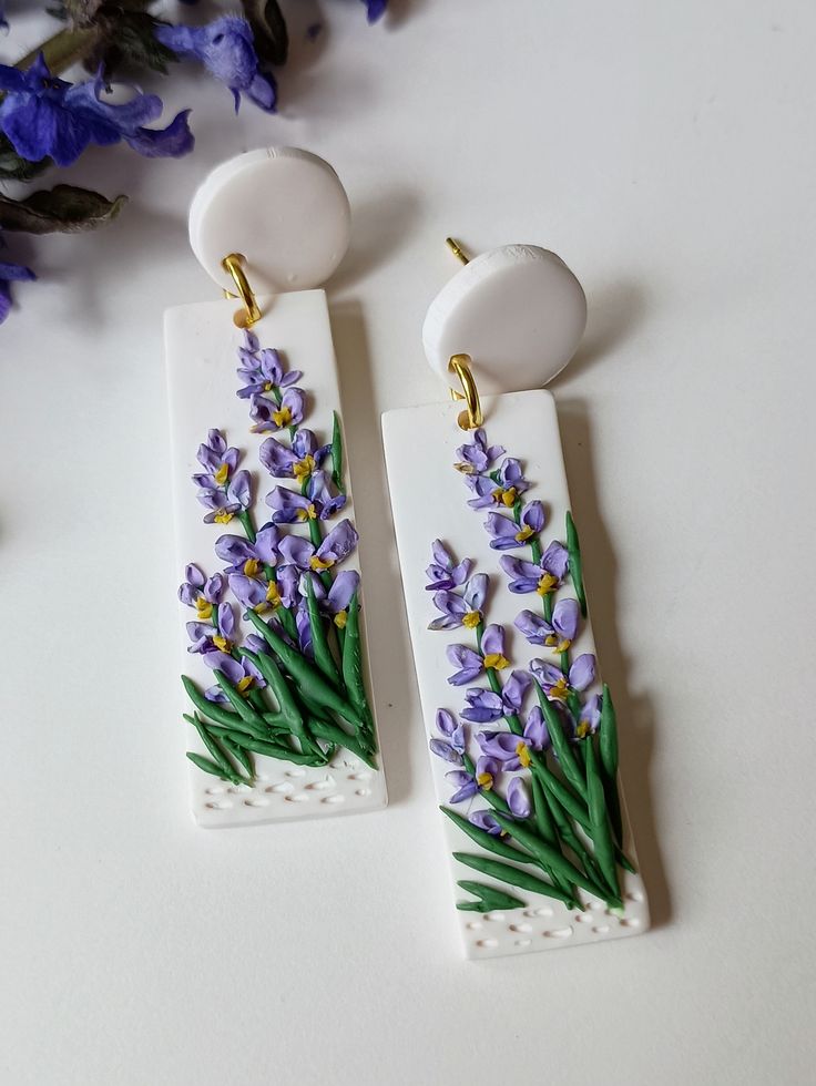 the earrings are decorated with purple flowers