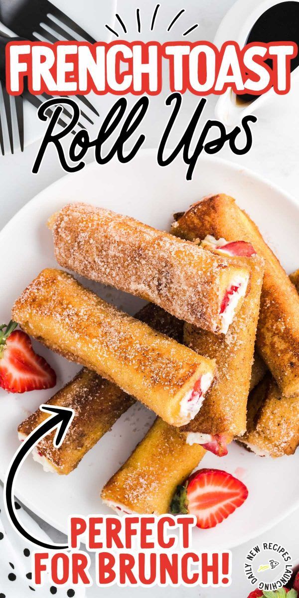 french toast roll ups on a plate with strawberries