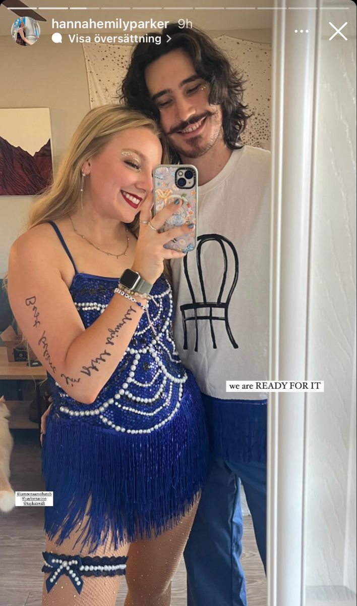 a man and woman taking a selfie in front of a mirror