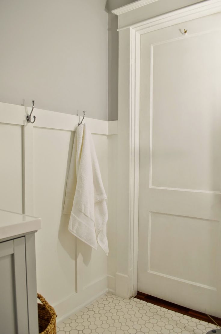 a white towel hanging on the wall next to a door