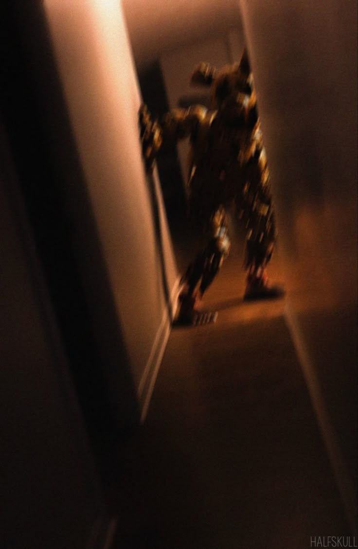 a blurry image of a robot walking down a hallway