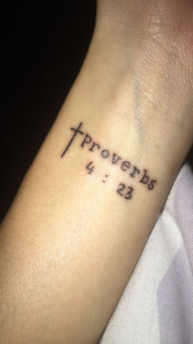 a wrist tattoo with the words provers 4 - 13 written on it