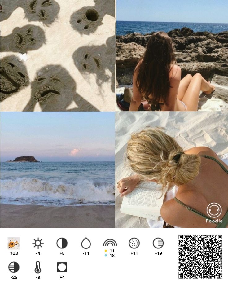 a woman sitting on top of a beach next to the ocean and footprints in the sand